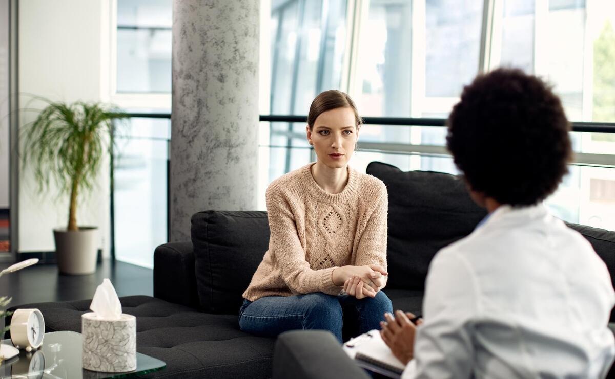 Young woman having a meeting with psychologist at the clinic