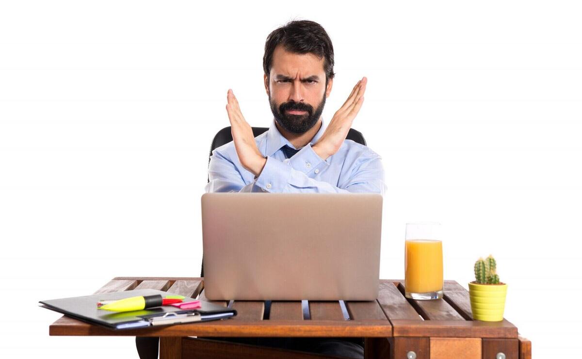 Businessman in his office making stop sign