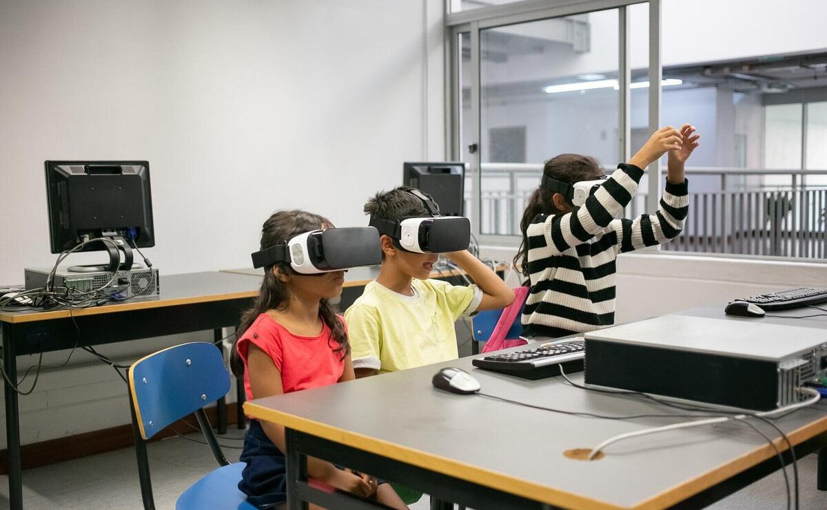 Cute multiethnic kids learning to use virtual reality glasses