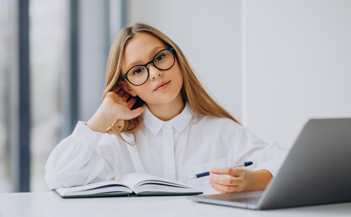 Cute girl studying on the computer at home