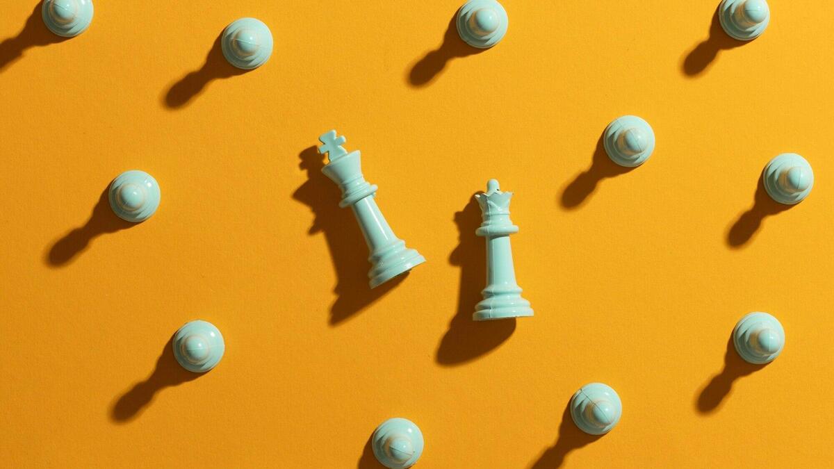 White chess pieces on yellow background