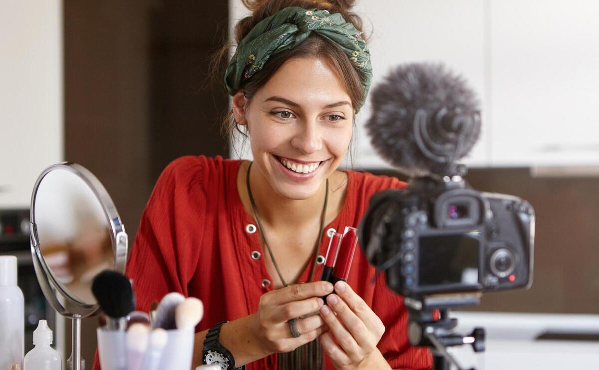 Female vlogger filming makeup video