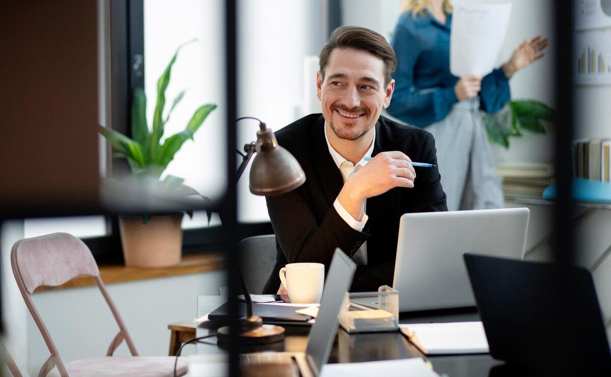 Medium shot smiley man at desk