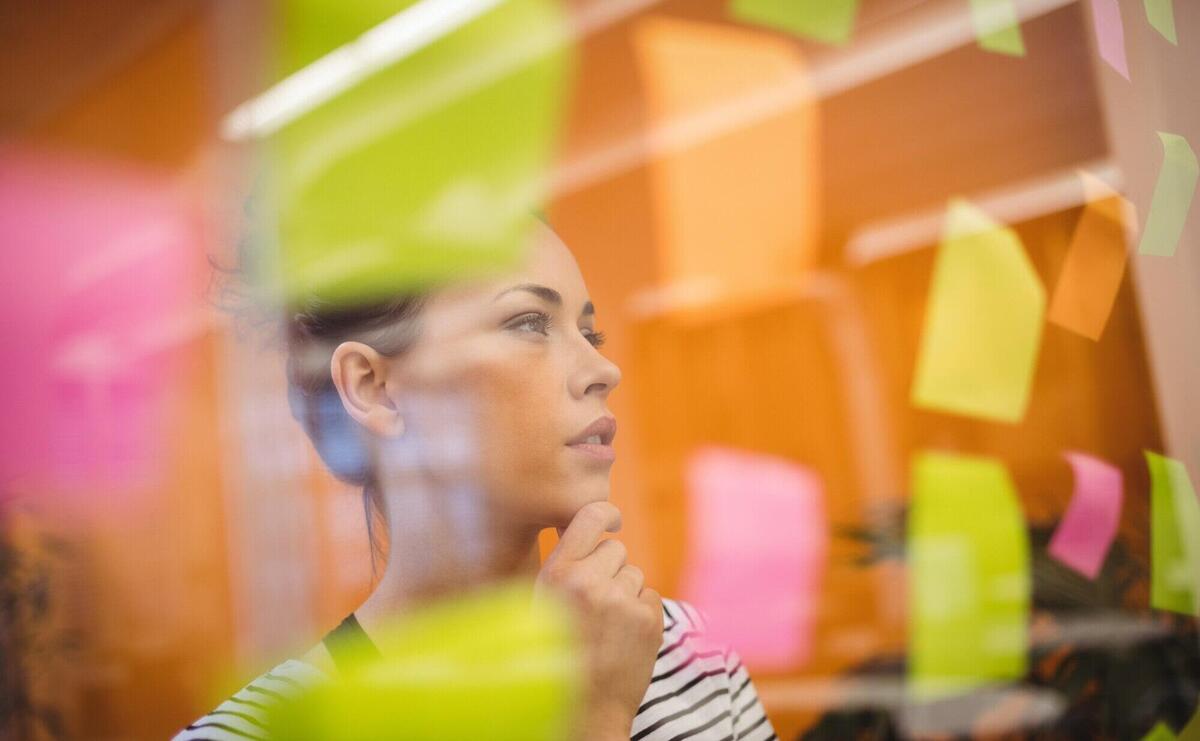 Female executive reading sticky notes