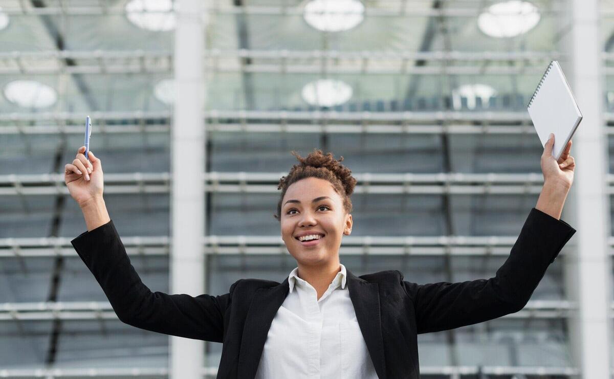 Excited woman with arms up