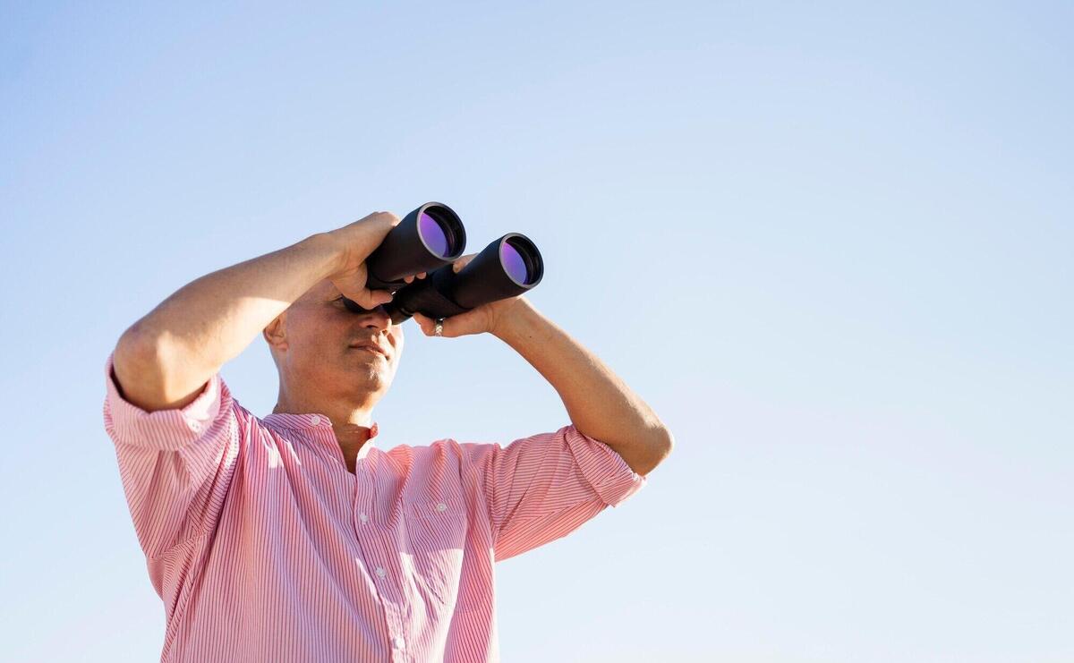 Low angle man watching through binocular