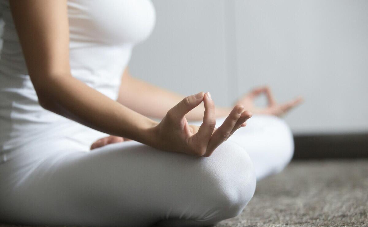 Woman sitting in Lotus closeup