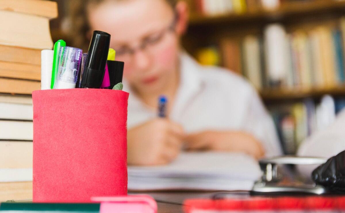 Girl studying at desk with stationery