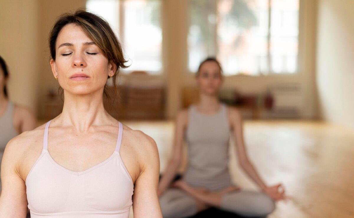 Yoga teacher at class teaching attendants