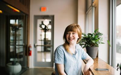 woman sitting in front of brown wooden table