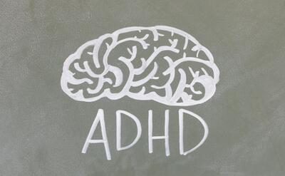 A logo with a brain and ADHD text.