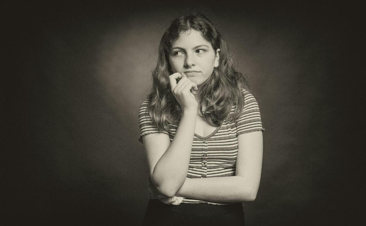 woman in stripe shirt covering her mouth with her hand