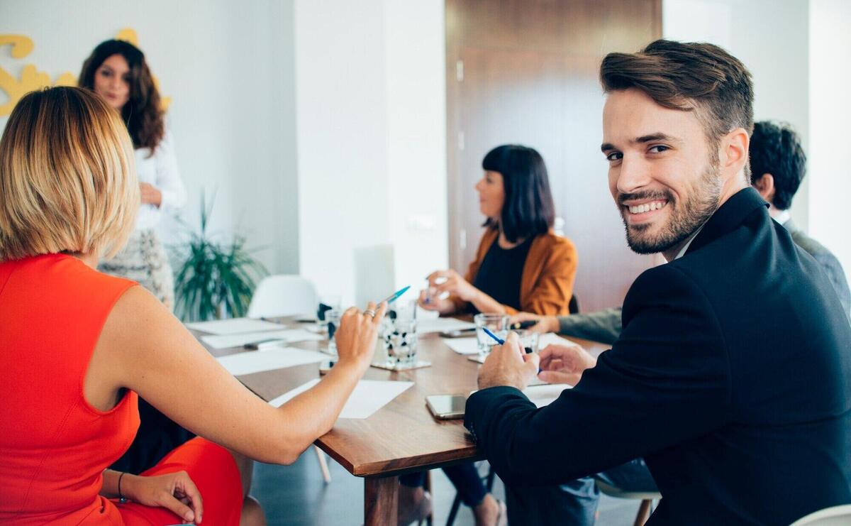 Young businessman smiling at the meeting