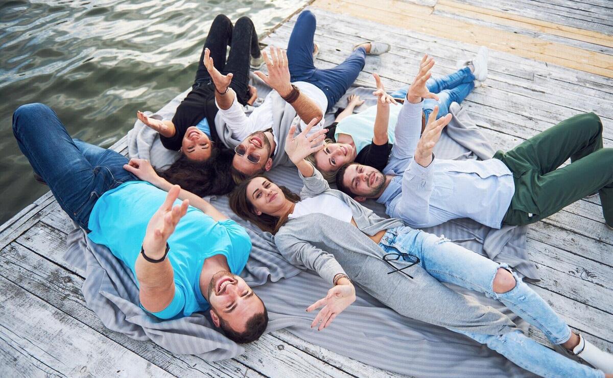 A group of young and successful people on vacation Friends enjoying a game on the lake. Positive emotions.