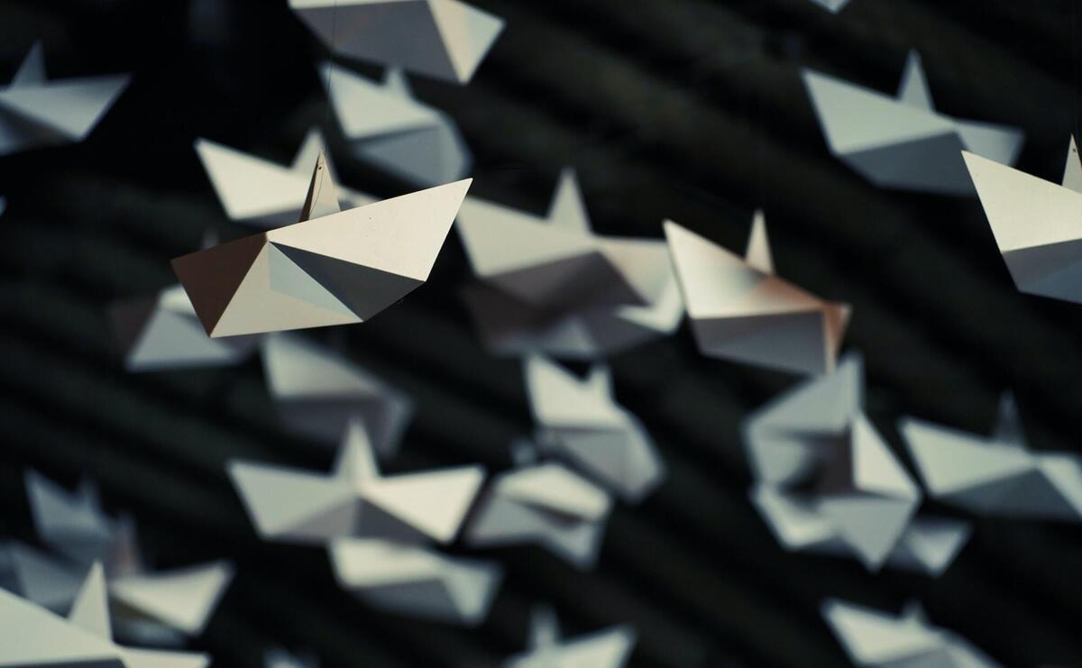 Origami airplanes on black background