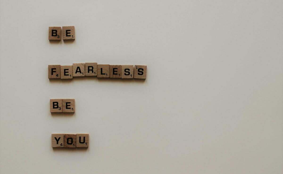 scrabble tiles forming be fearless be you phrase