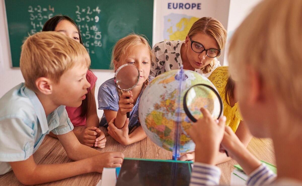 Children discovering new places in globe