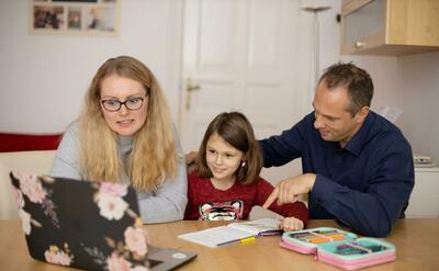 Parents learning together with child during homeschooling