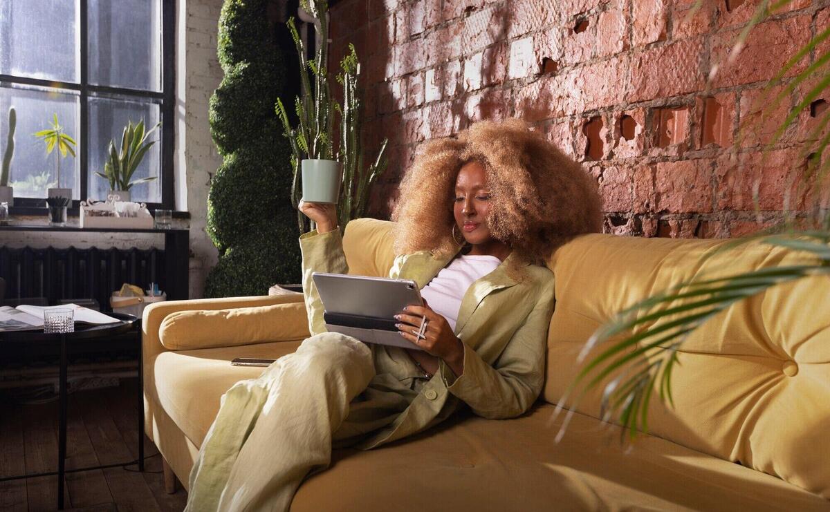 Full shot woman reading on tablet