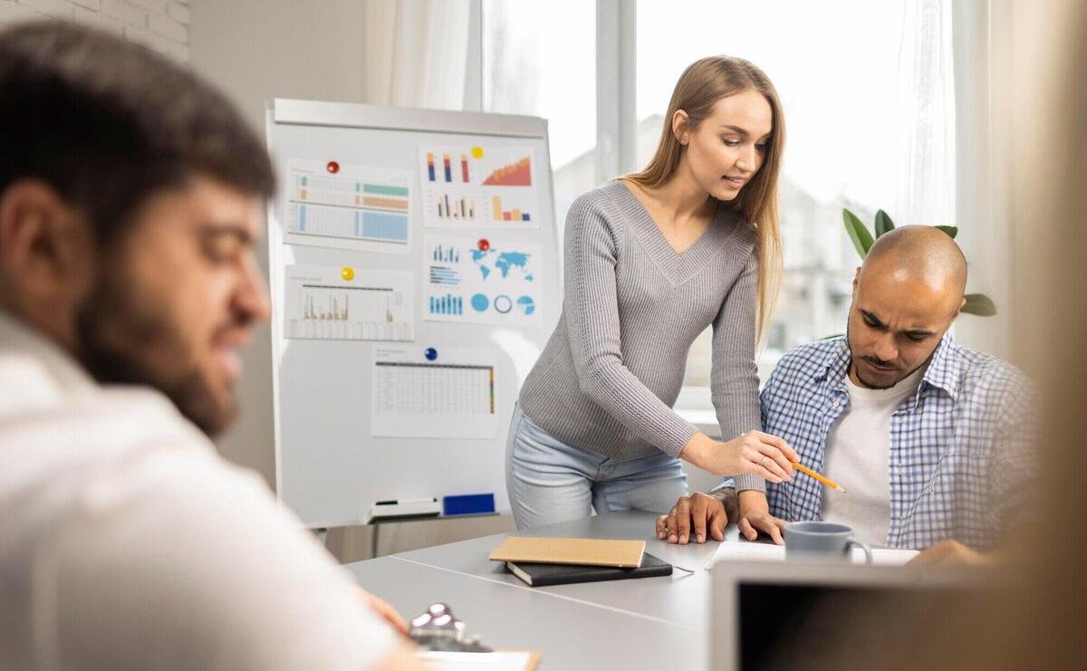 Pregnant businesswoman with male coworkers during a presentation