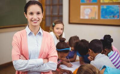 Teacher smiling at camera in classroom