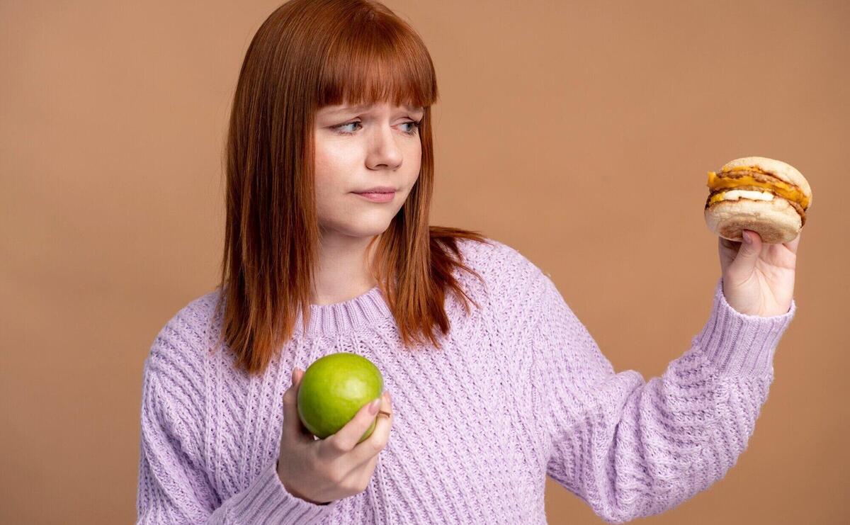 Woman with eating disorder deciding which food to eat