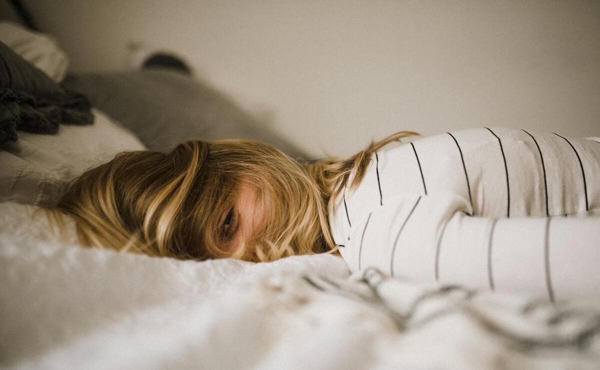 woman lying on bed