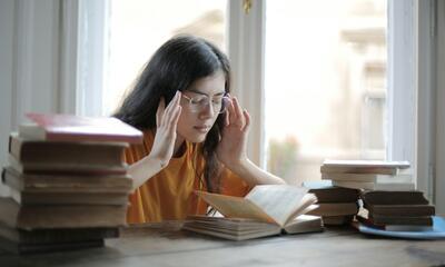 A Weary Female Student Having a Headache