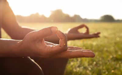 Side view of man meditating outdoors