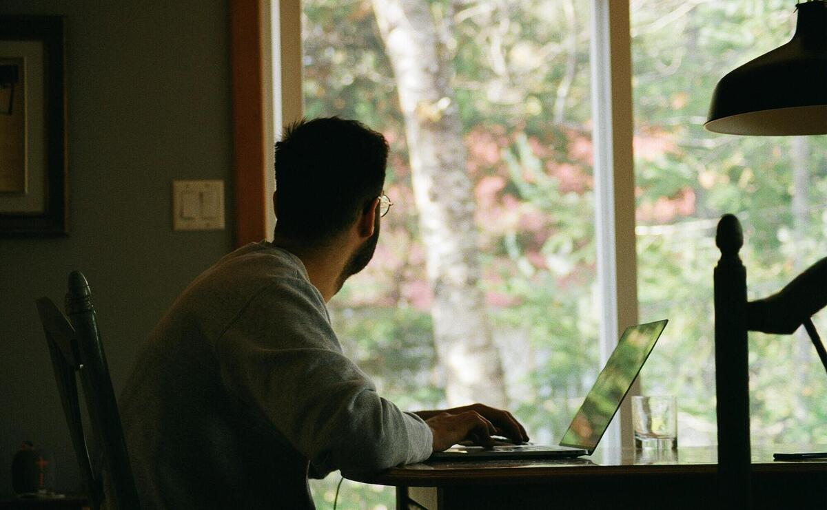 man in gray hoodie using laptop computer