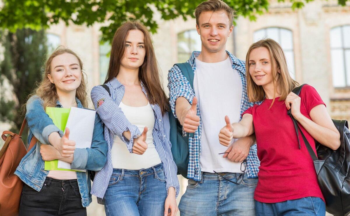 Group of young students in front of school building